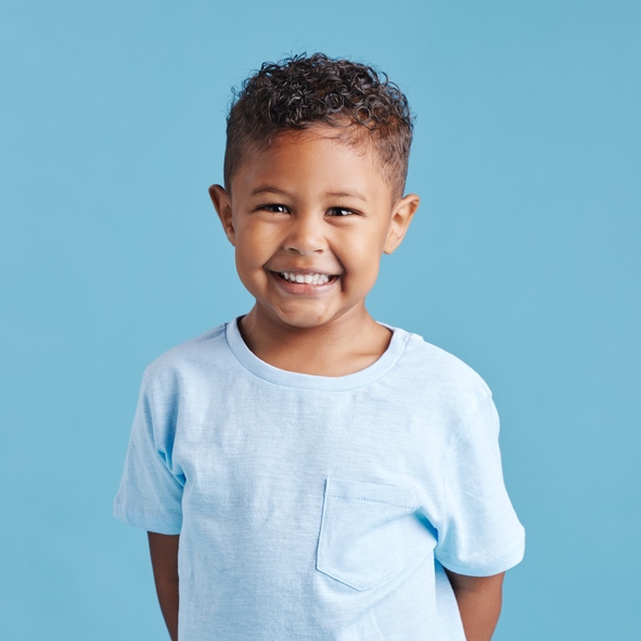 Happy kid smiling after a successful pediatric dental tooth extraction in Pflugerville, TX
