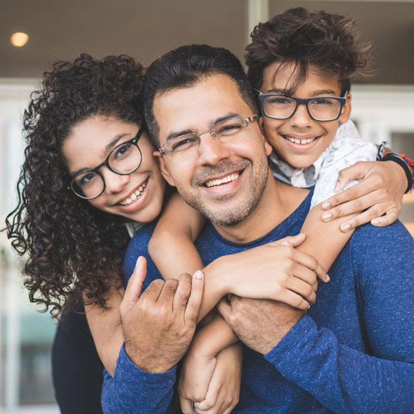 father and two children smiling