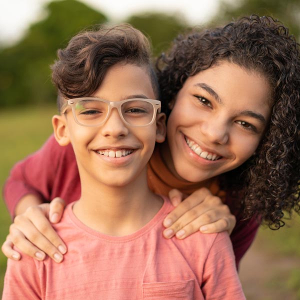 brother and sister smiling