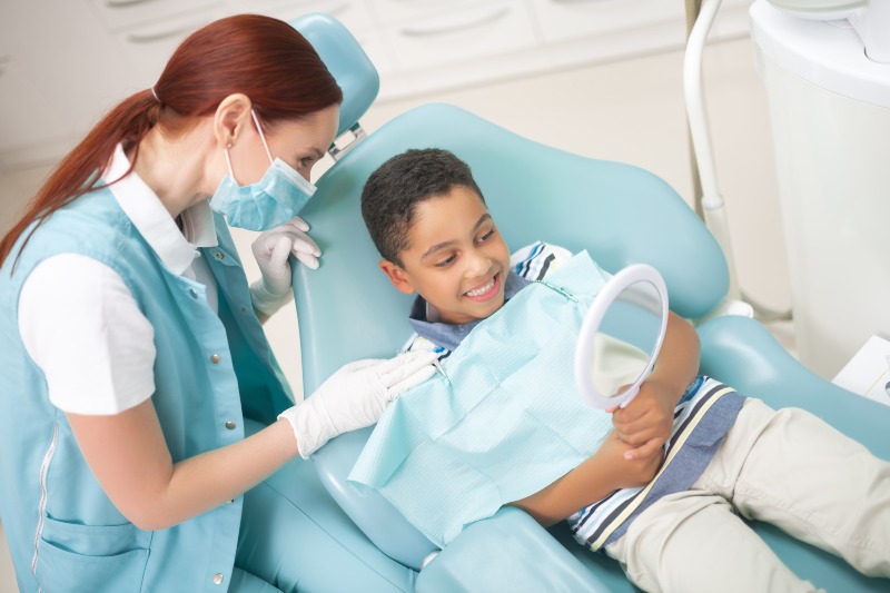A dentist showing results after conducting a kids' dental cleaning & examination in Pflugerville